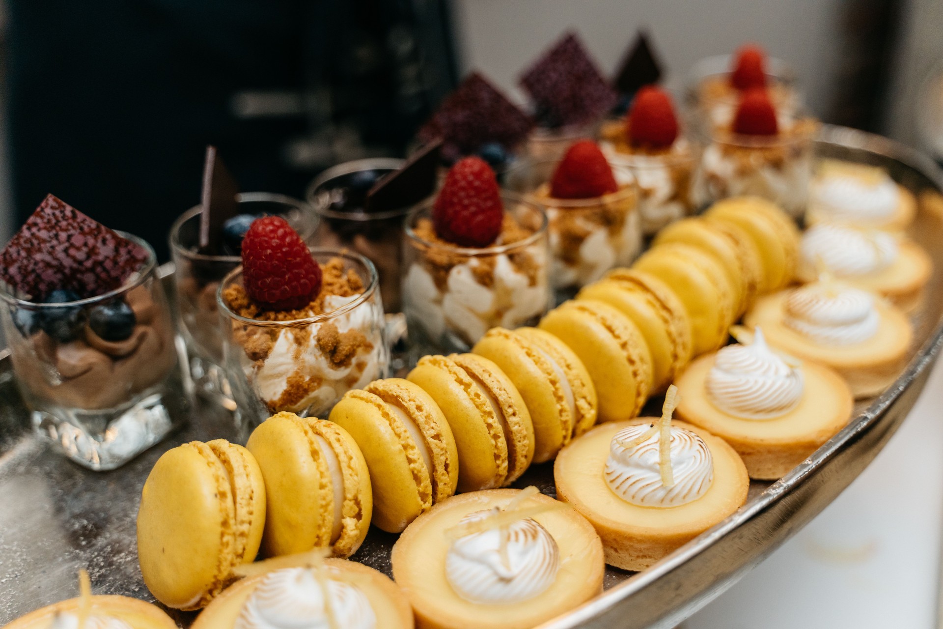 elegant dessert buffet with chocolate mousse, tarts, macaroons and panna cotta